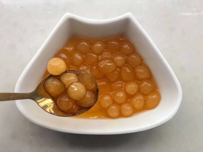 golden boba in a white plate
