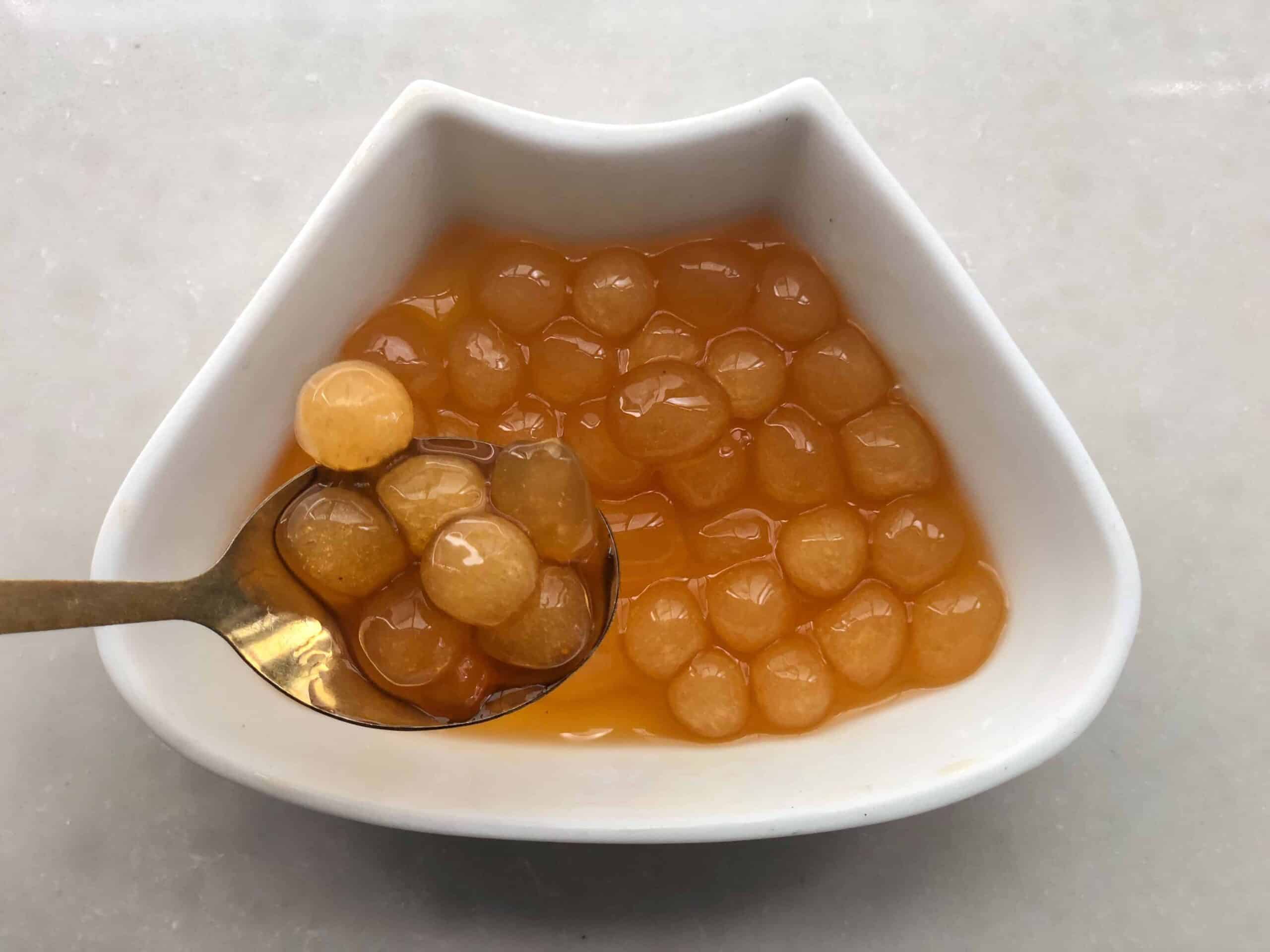 golden boba in a white plate