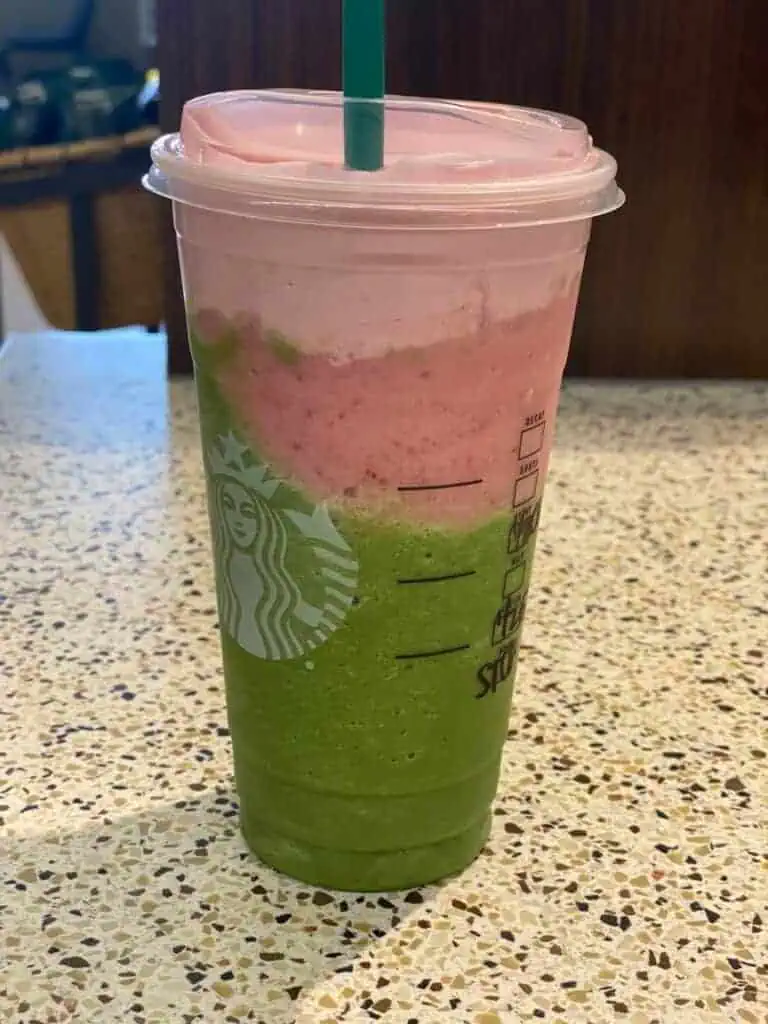 Matcha frap with strawberry purée on the bottom topped with strawberry cold foam