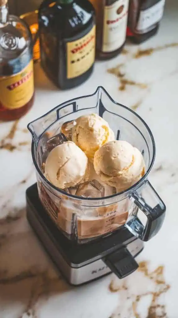 a blender with Baileys, Kahlúa, vodka, 3 scoops of vanilla ice cream, and ice cubes inside