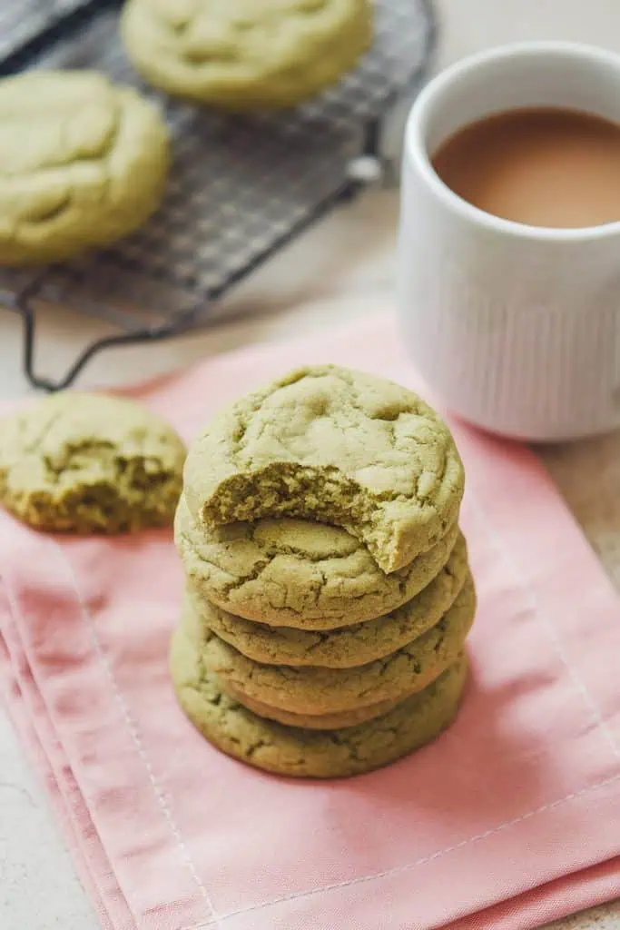 green-colored cookies with a bite taken out of the topmost cookie