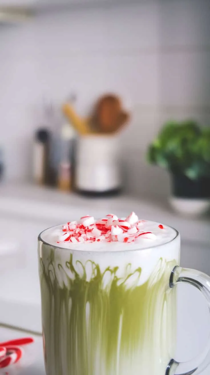 A delicious Peppermint Matcha Latte topped with crushed peppermint pieces