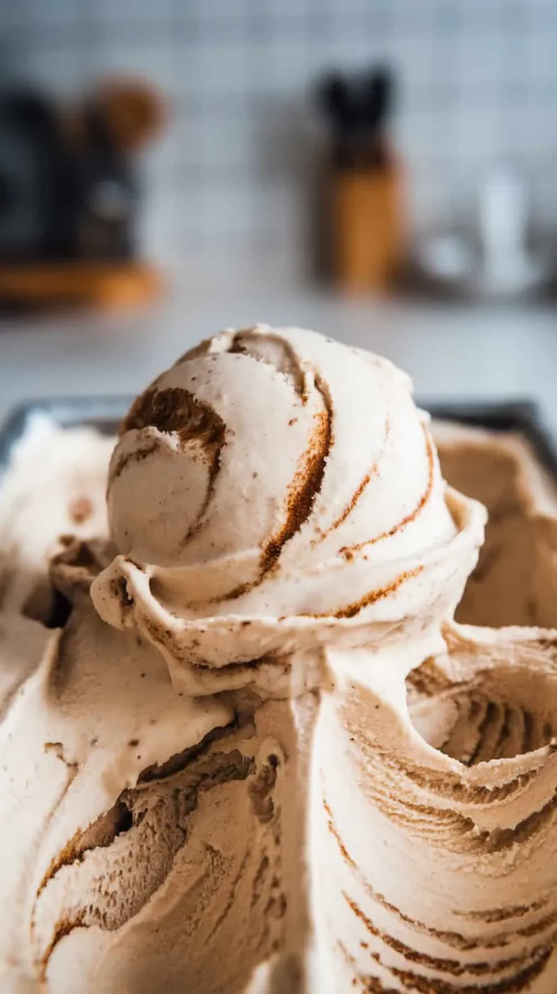 A close-up of a scoop of cinnamon swirl coffee ice cream.