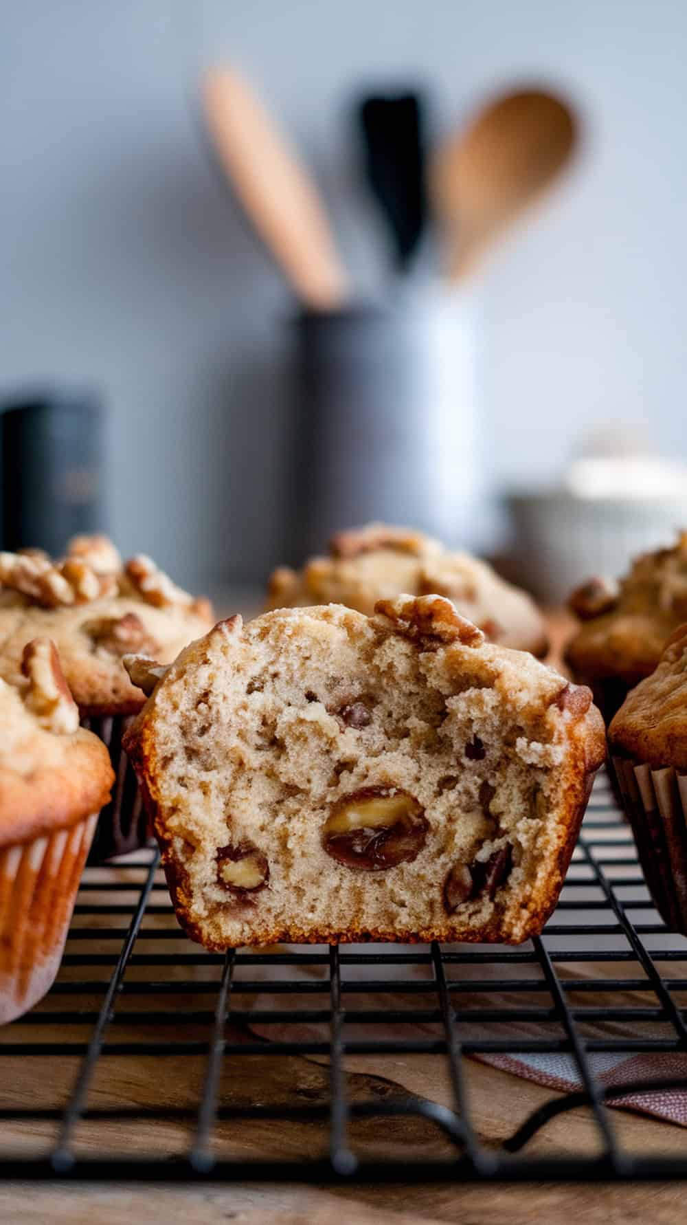 Freshly baked banana nut muffins on a cooling rack.
