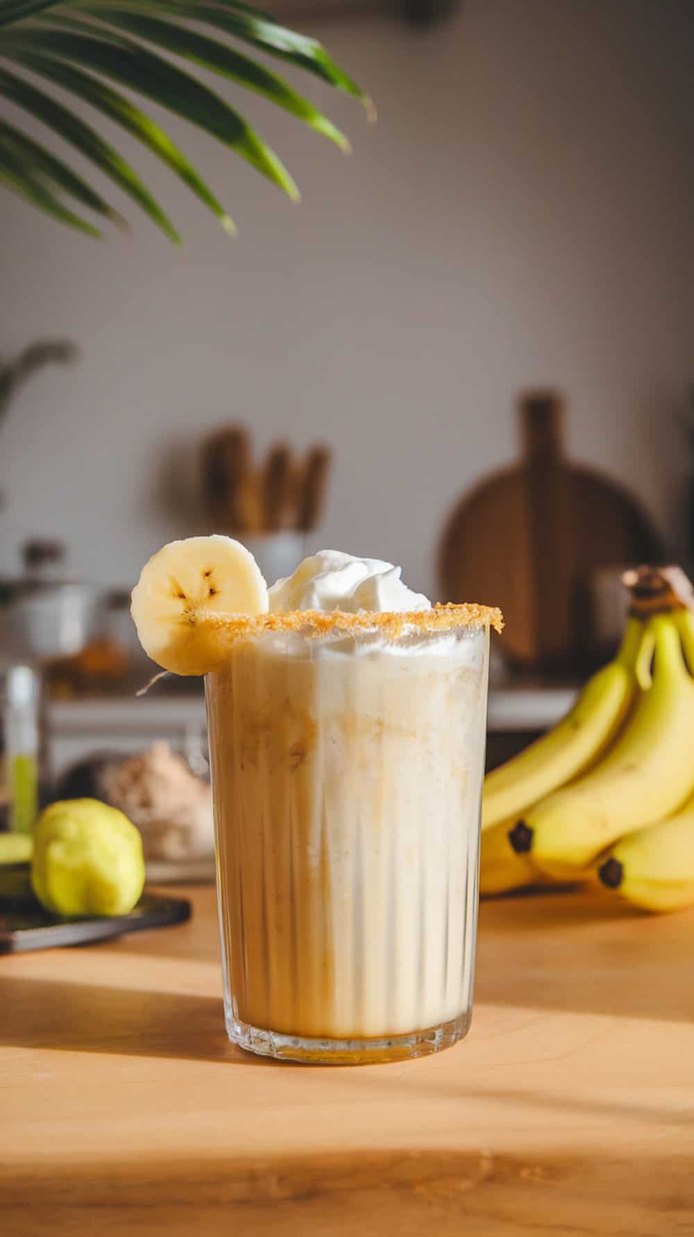 A refreshing Baileys Banana Colada cocktail topped with whipped cream and banana slices.