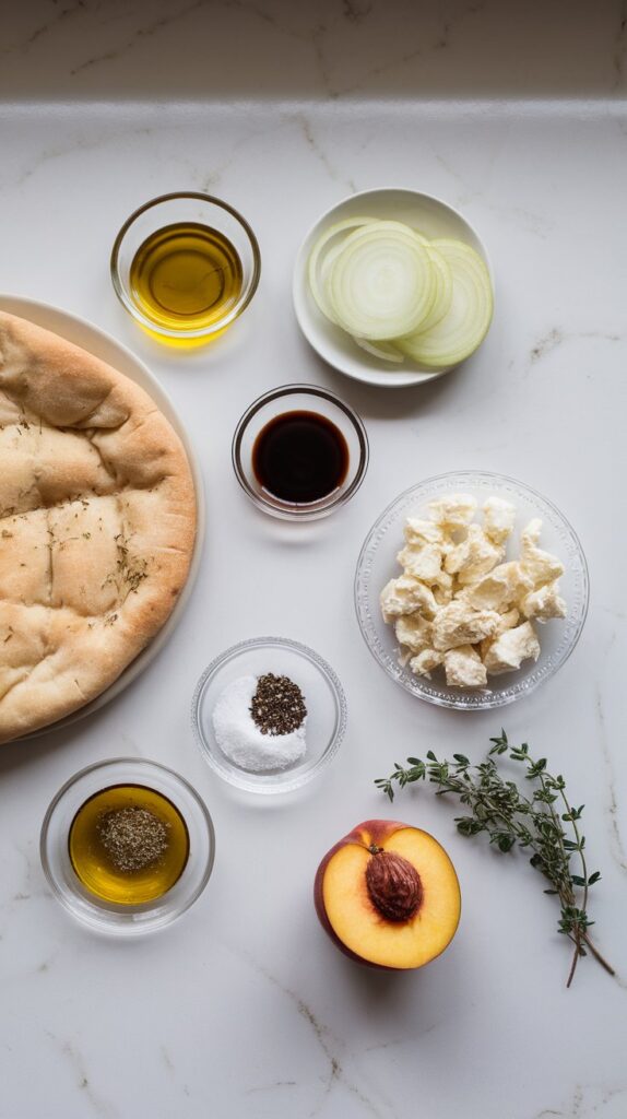  1 flatbread, 1 tablespoon olive oil in a small clear plate, 1 large yellow onion thinly sliced on a small plate, 1 teaspoon balsamic vinegar in a shallow glass dish, 2 oz soft goat cheese crumbled on a clear plate, 1 ripe peach thinly sliced on a white plate, 1 teaspoon honey on a clear glass saucer, small pinch of salt and pepper on a dish